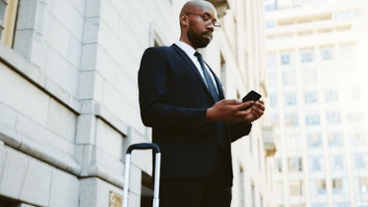 Man looking at his phone to book shuttle service