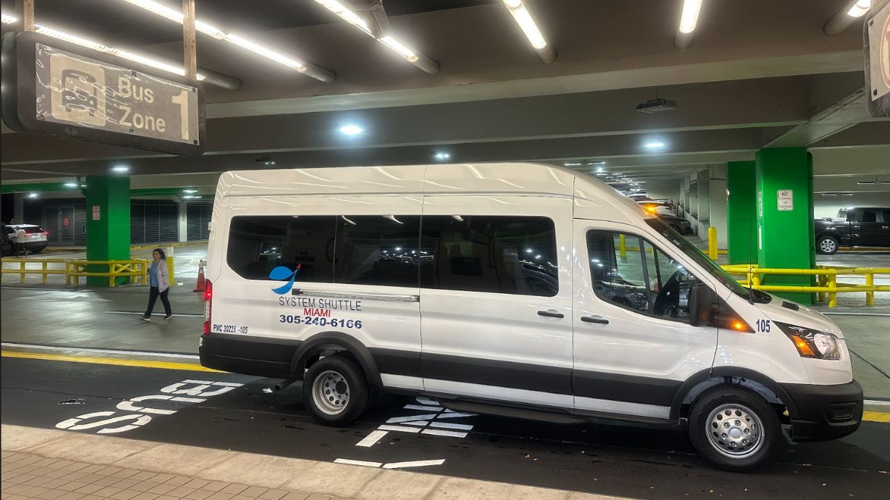 System Shuttle Miami white passenger van ready to pick passengers