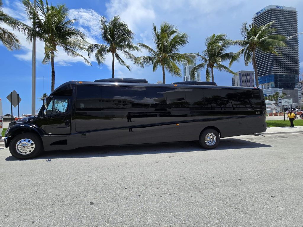Miami tour shuttle bus on waterfront road with tropical palm trees