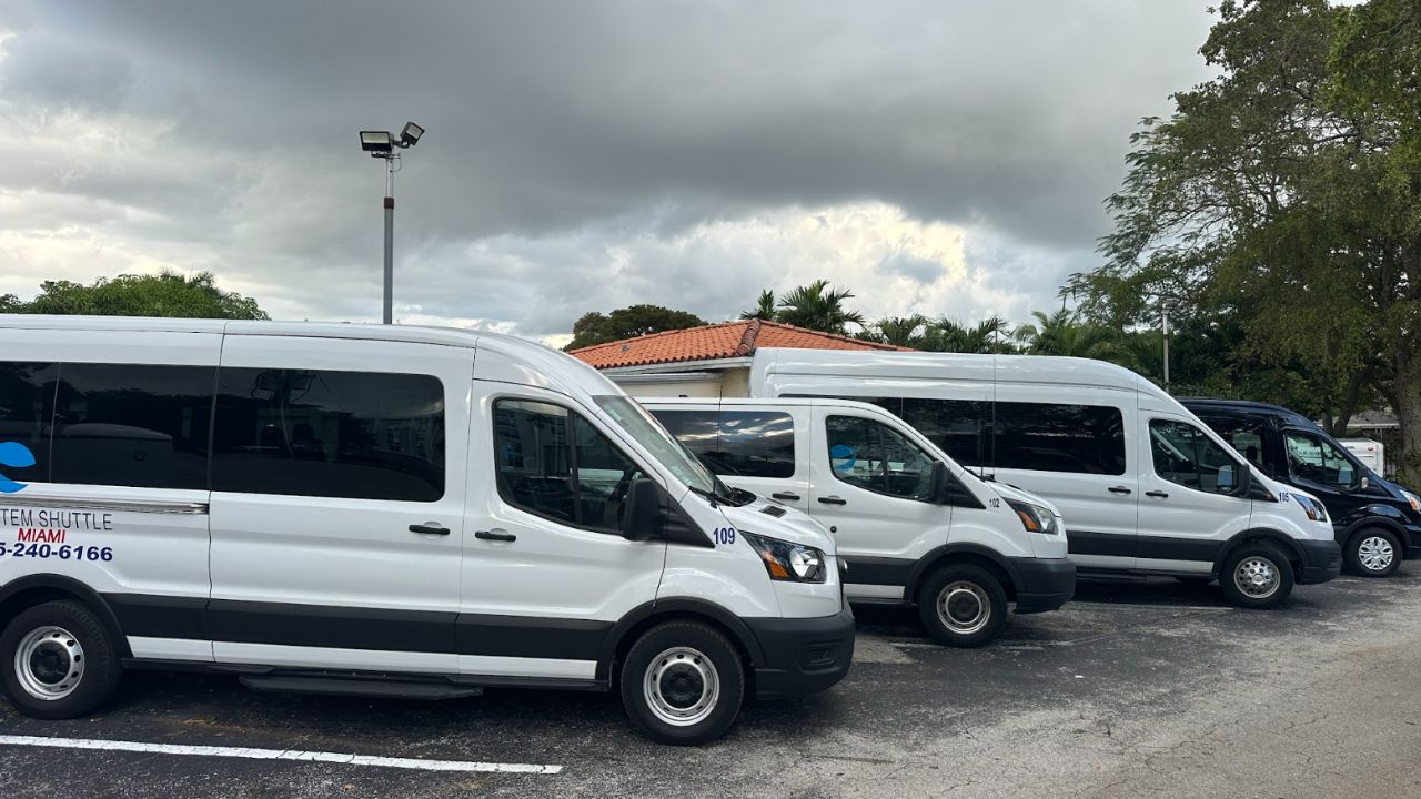  Fleet of shuttle vans parked for Miami transportation service
