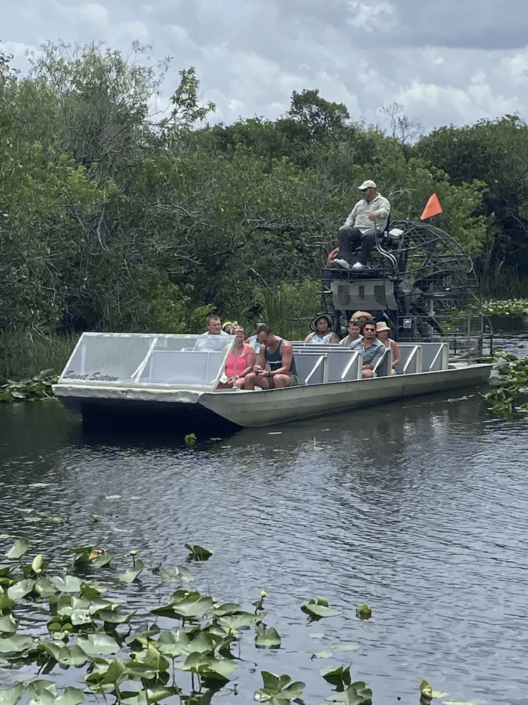 Everglades airboat tour with tourists exploring wetlands
