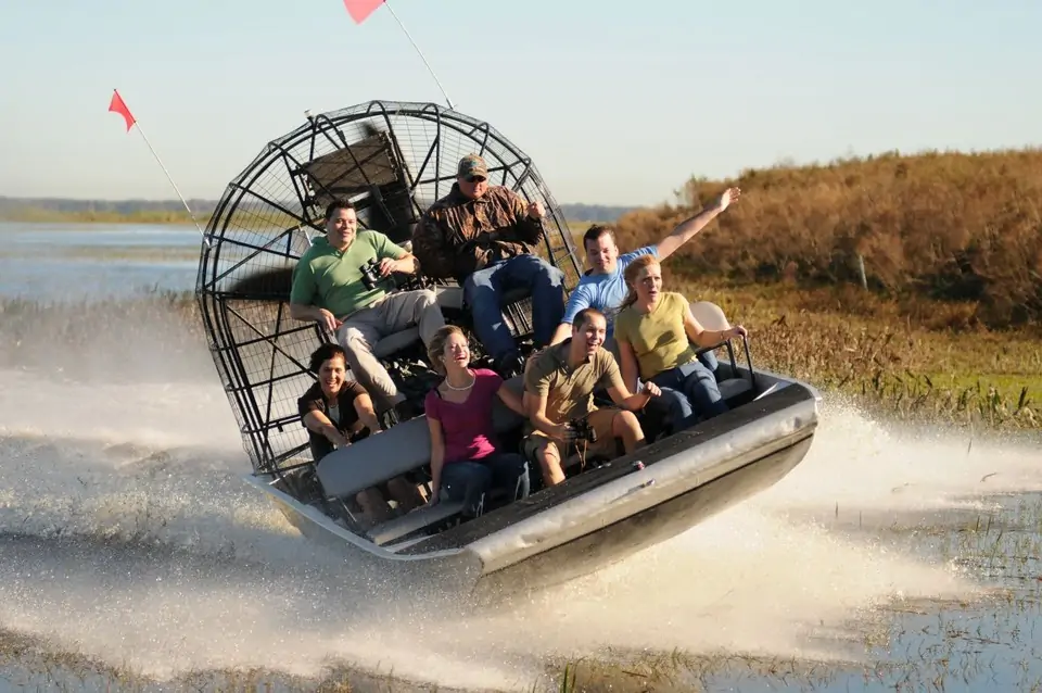 Tourists enjoying high-speed Everglades airboat ride through wetlands