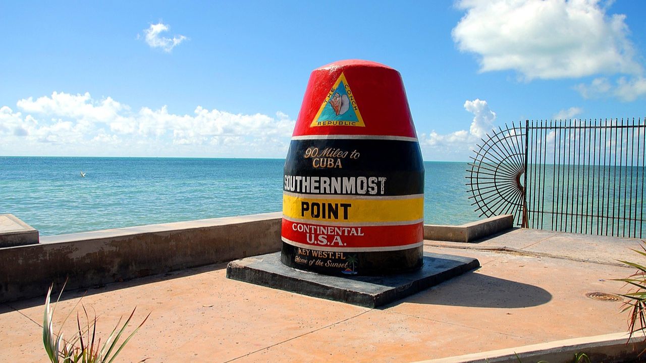 Southernmost Point buoy landmark in Key West, Florida, overlooking the turquoise waters of the Atlantic Ocean.
