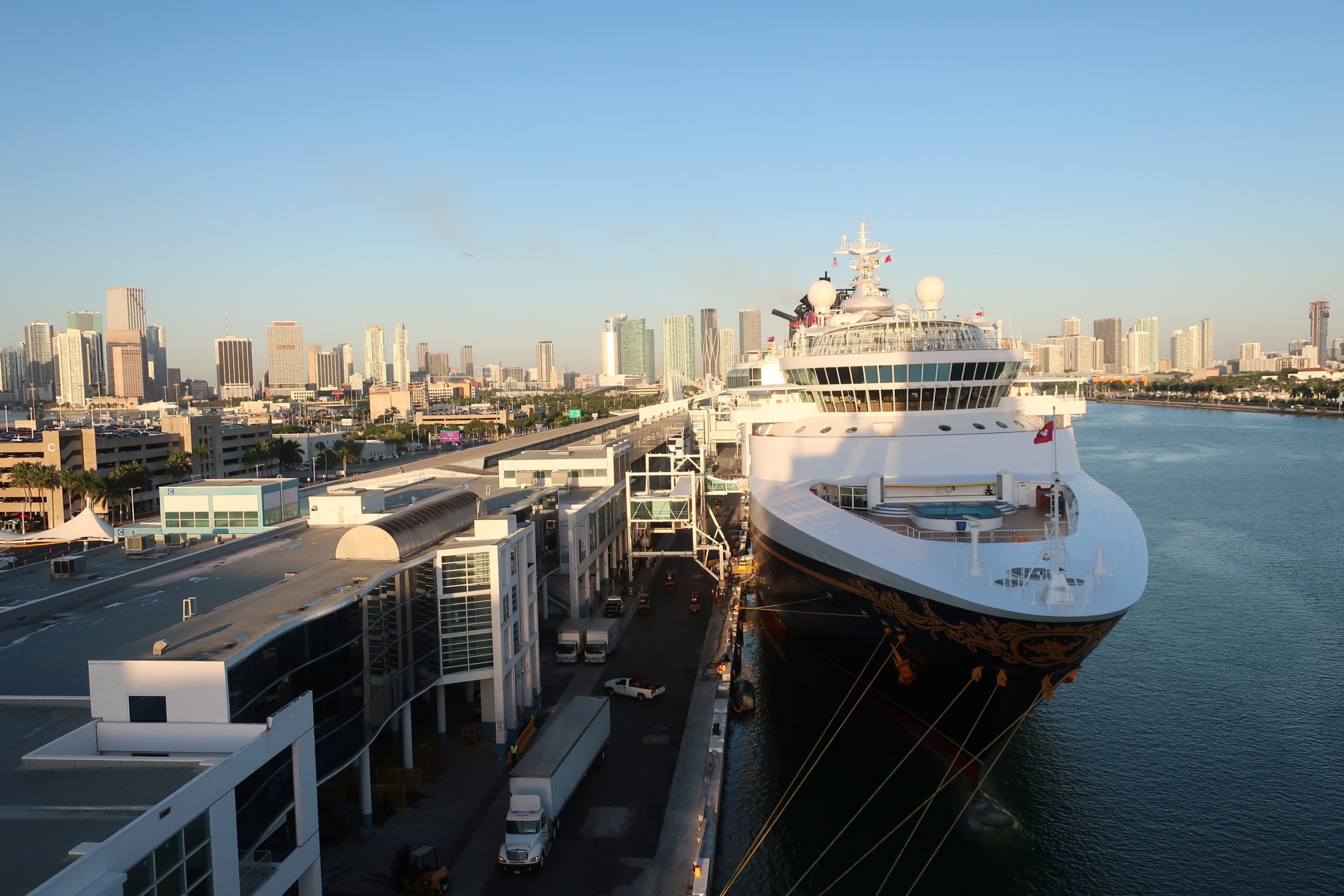 Cruise ship docked at PortMiami with downtown Miami skyline during a sunny morning