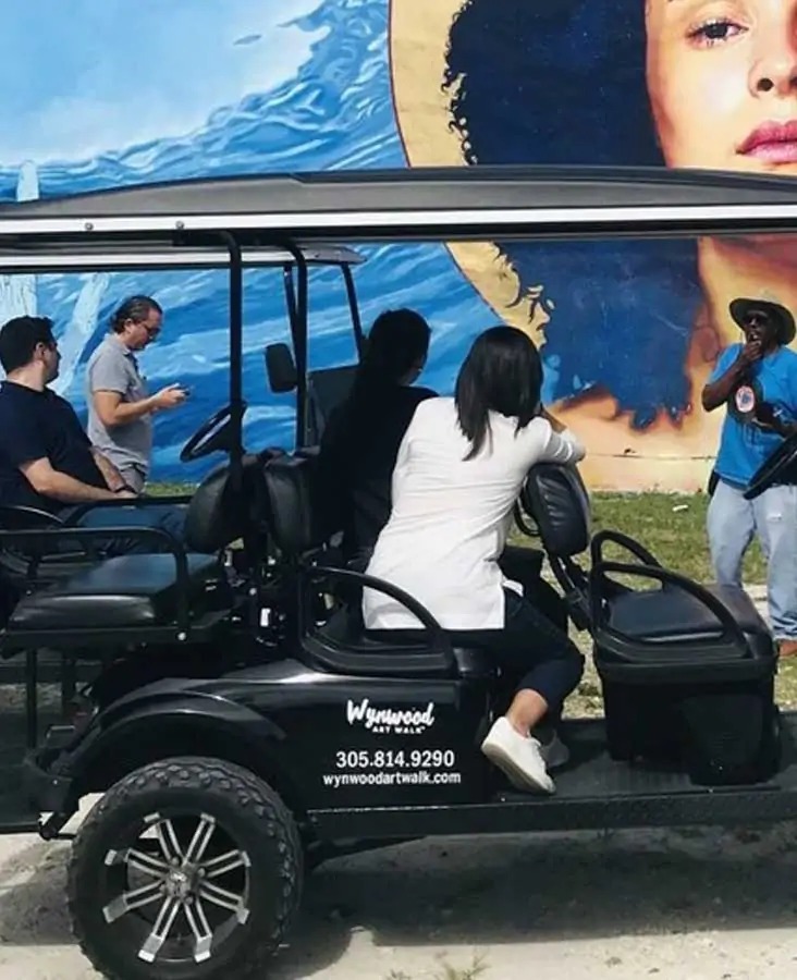 Guided golf cart tour exploring large-scale murals and street art in Wynwood Miami.