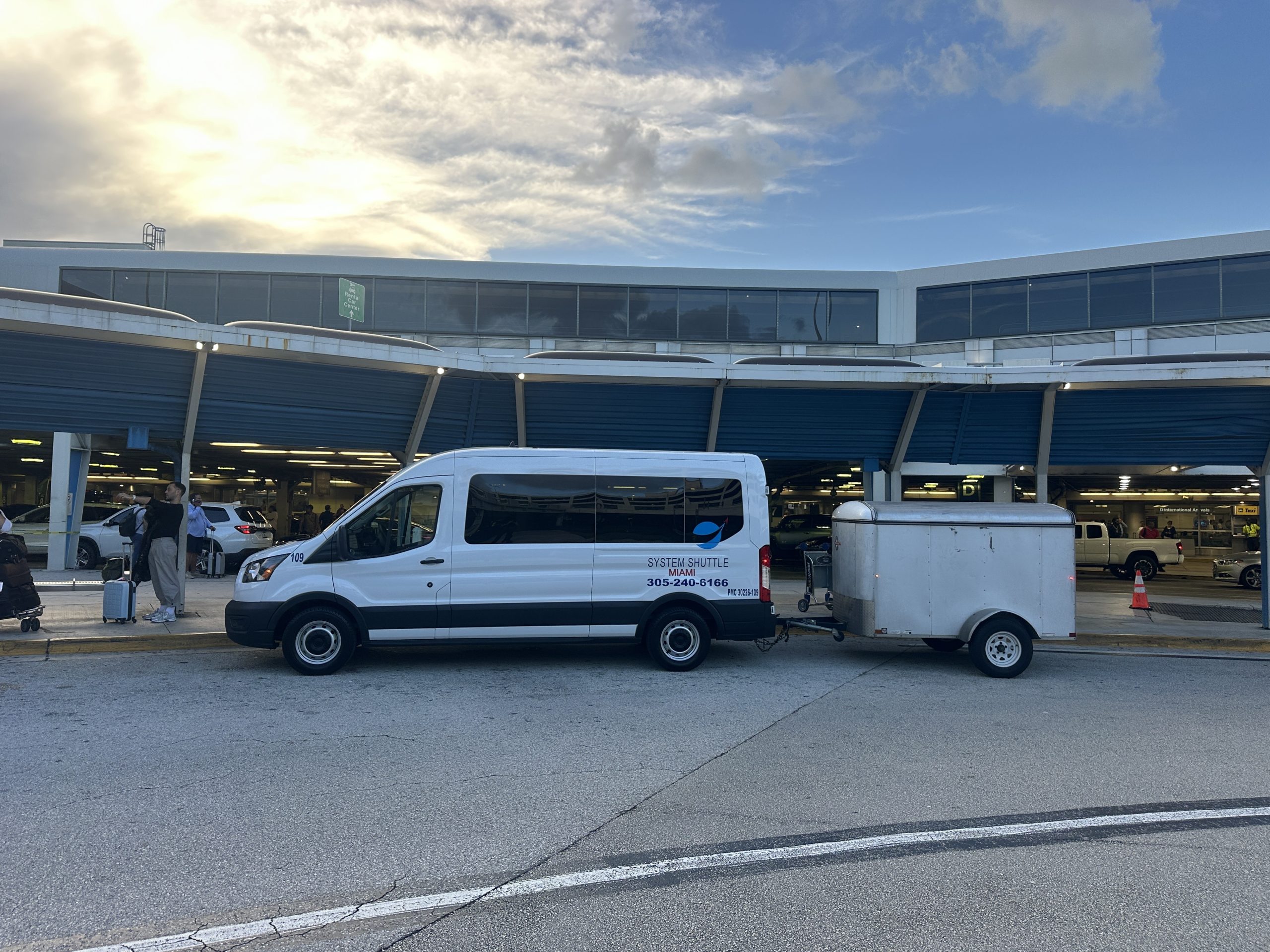 System Shuttle Miami airport shuttle van providing reliable passenger transportation and luggage transfer outside Miami International Airport.