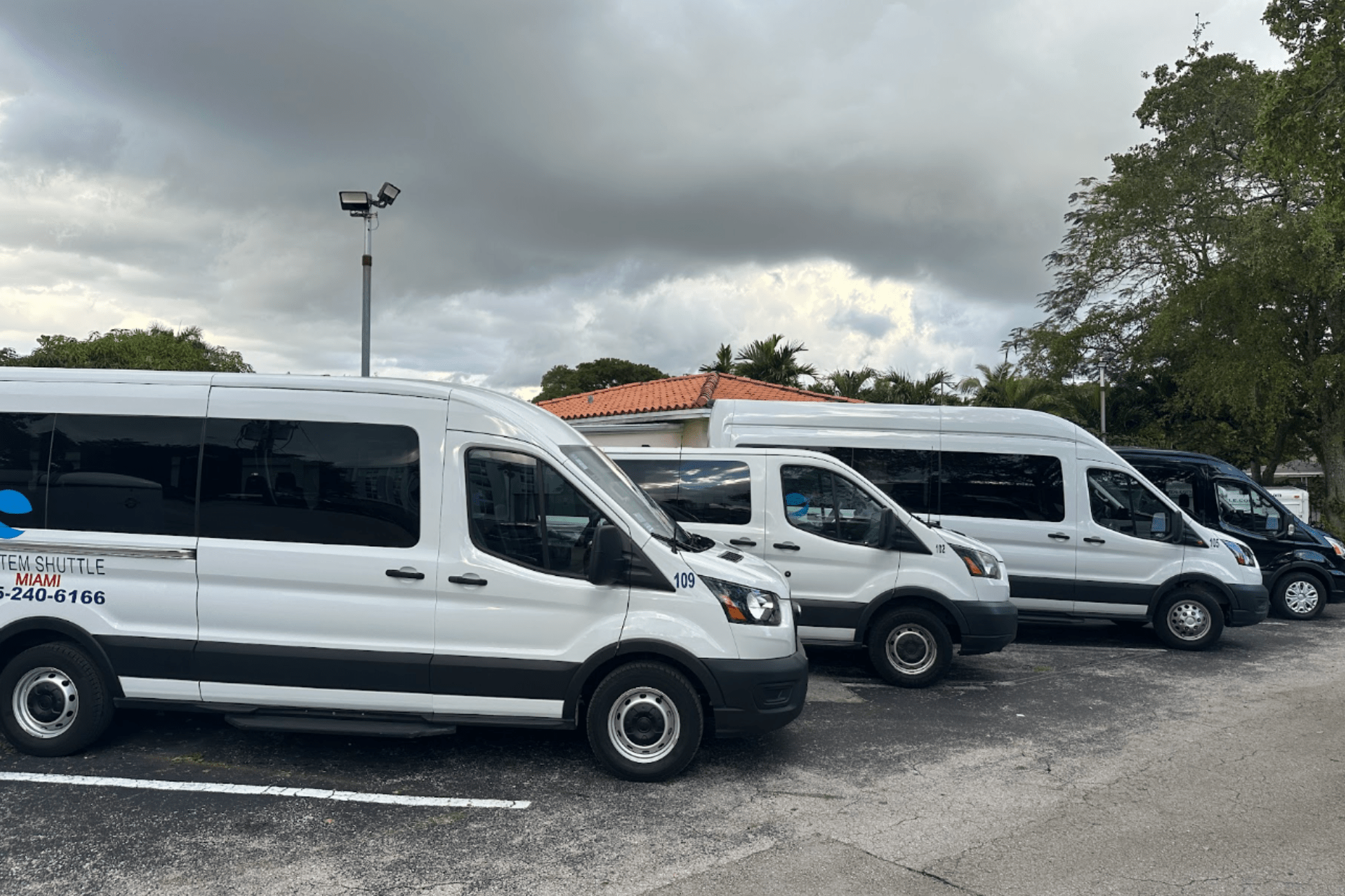 System Shuttle Miami passenger vans parked in a fleet lot