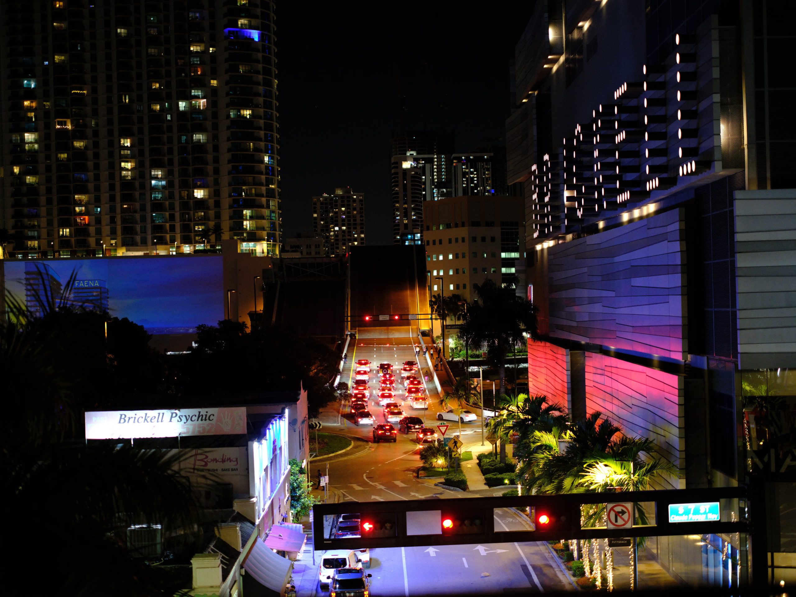 Brickell Miami streets illuminated at night with high-rise buildings and traffic