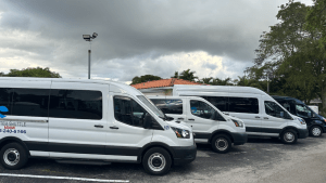 System Shuttle Miami passenger vans parked and ready for group transportation.