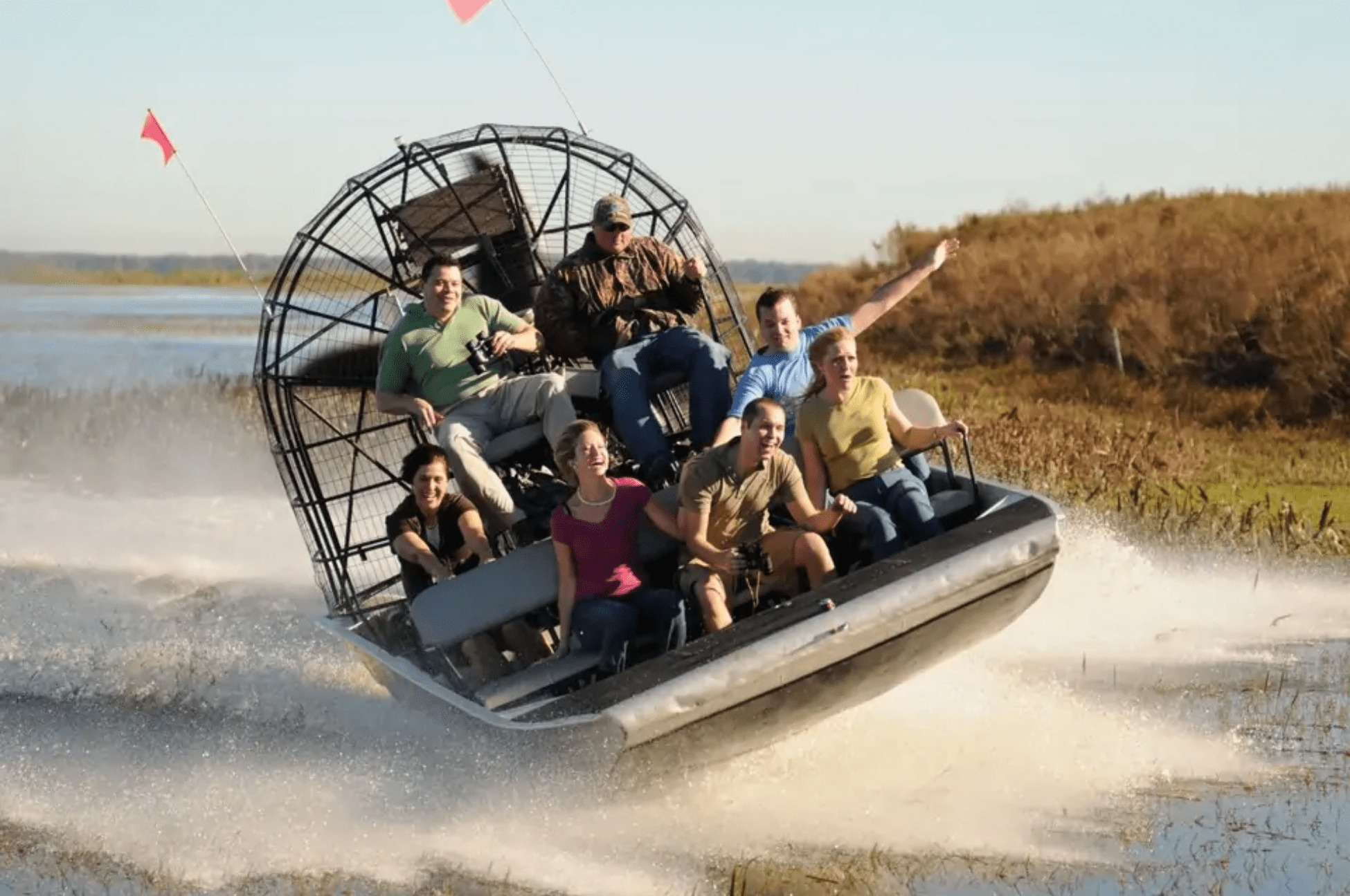 Travelers enjoying an exciting Everglades airboat tour near Miami.