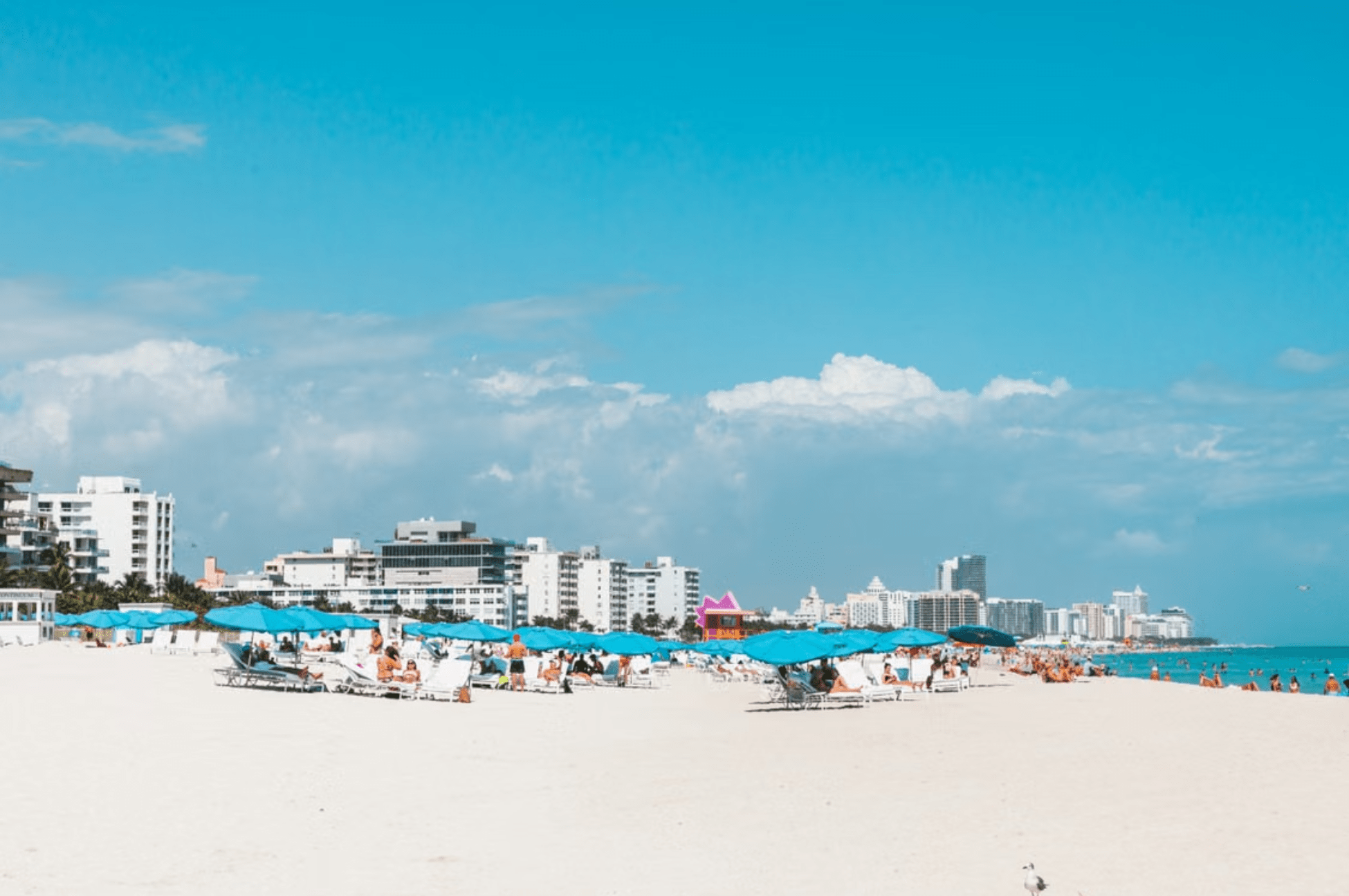 Visitors relaxing on sunny South Beach during December in Miami.