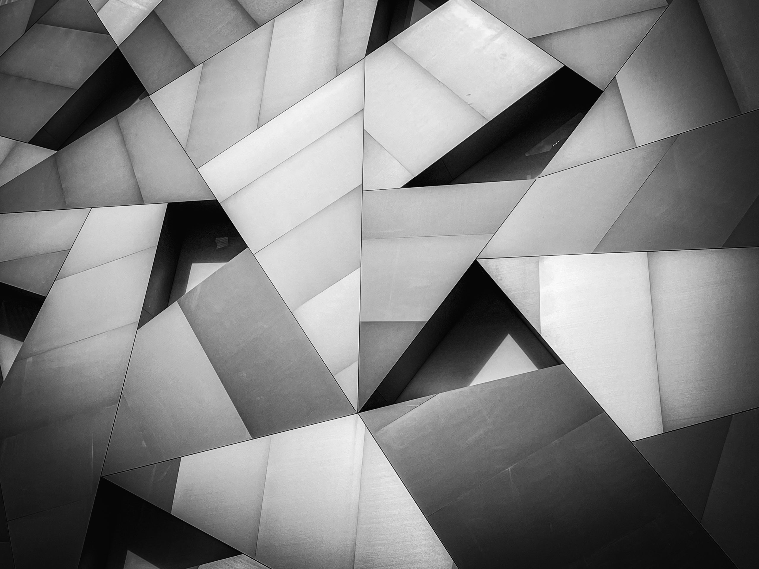 Monochromatic close-up of dynamic triangular architectural facade design at Institute of Contemporary Art