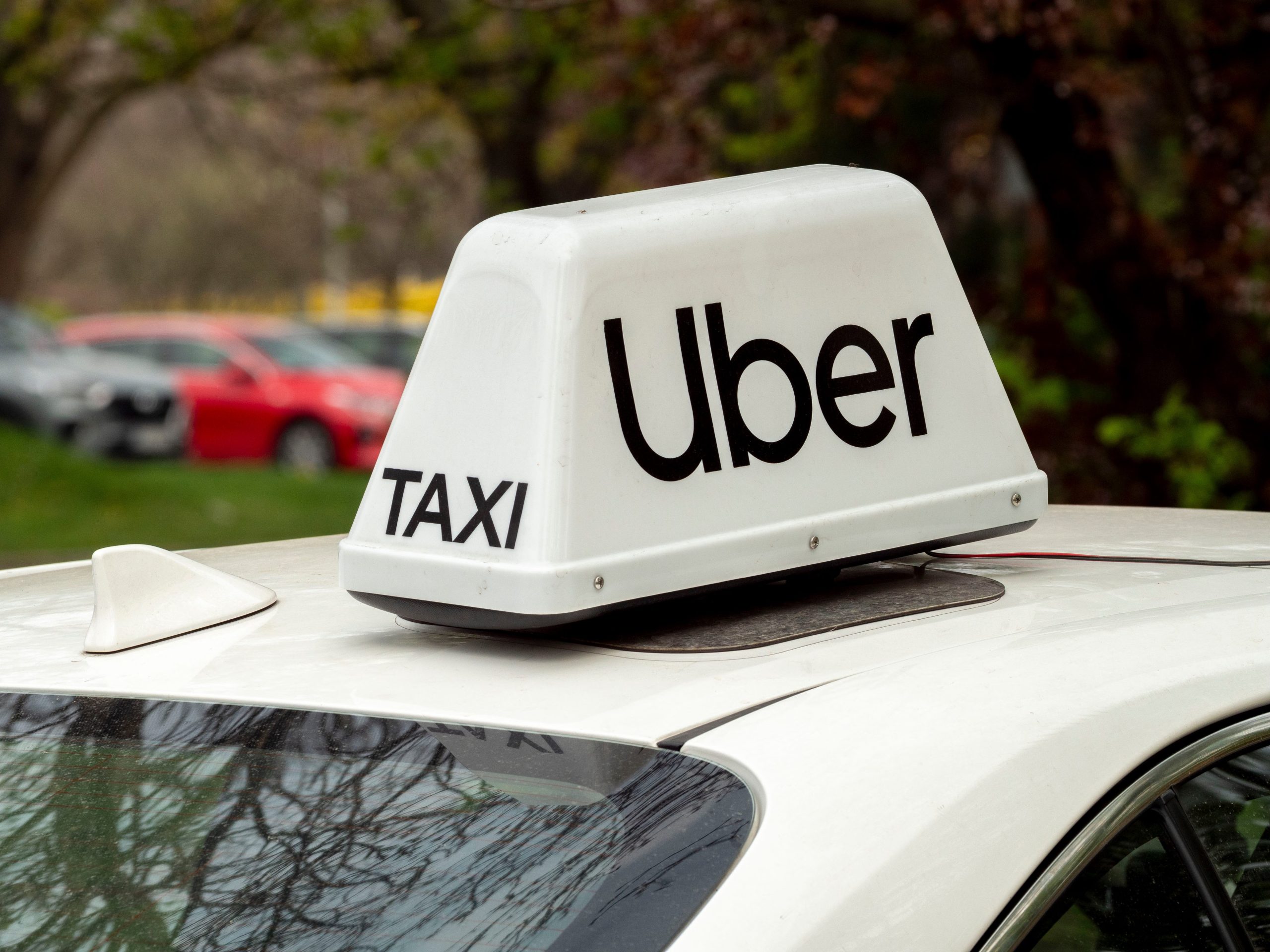 Uber taxi roof sign on a white car