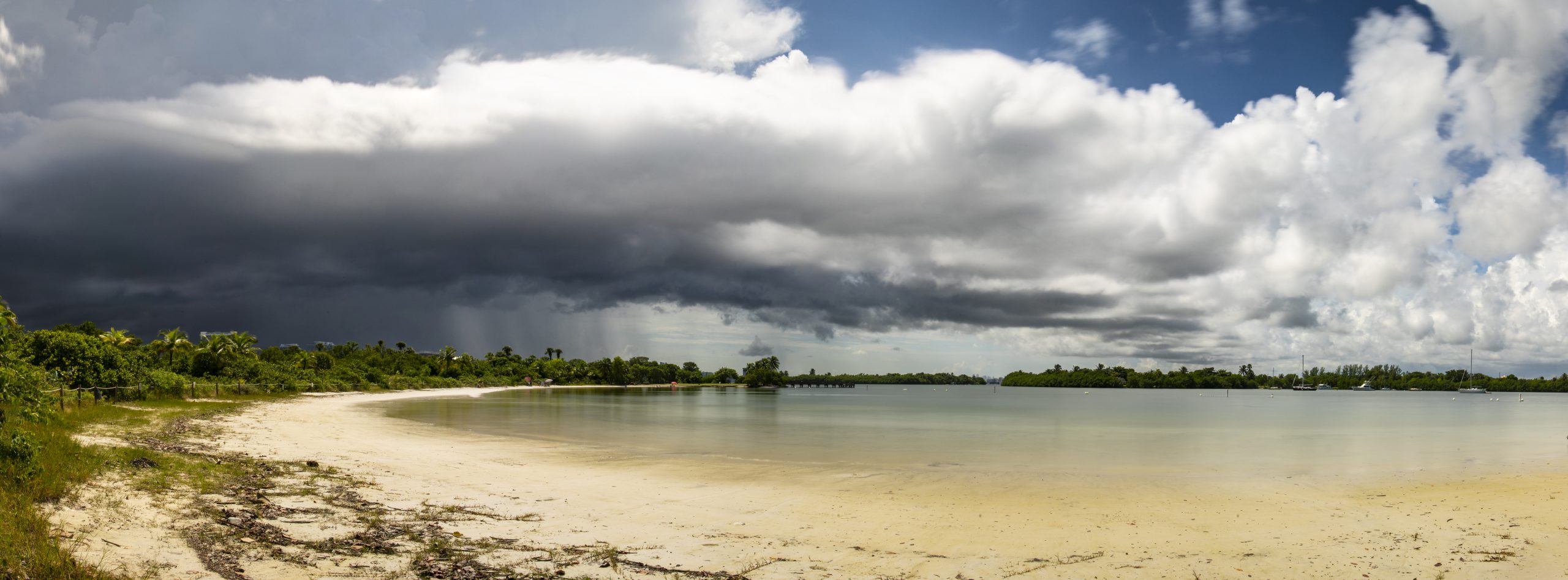 Wide panoramic view of Oleta River State Park under storm clouds.